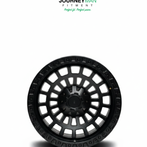 Journeyman Fitment matte black off-road wheel with a multi-window mesh pattern and industrial bolt border.